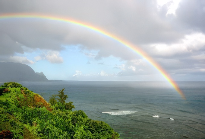 A stunning rainbow arcing into the ocean.